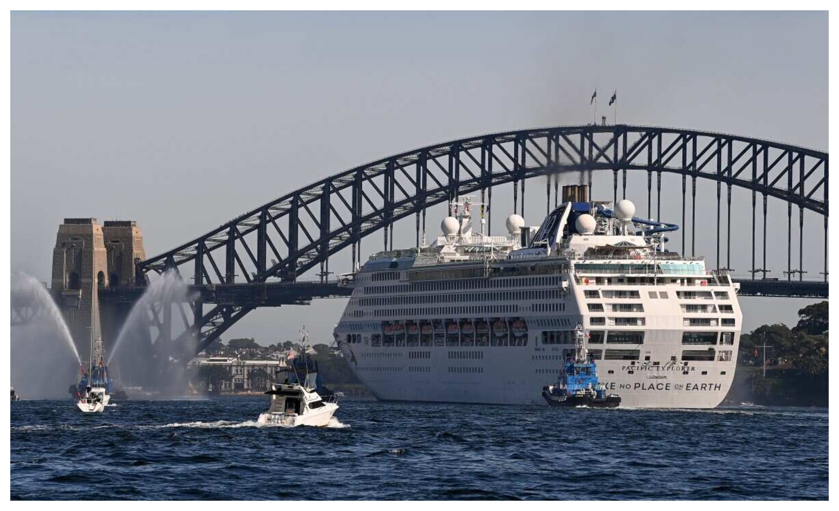 Tug boats with water cannons form a guard of honour and escort the P&O Cruises Australia flagship Pacific Explorer is it enters Sydney Harbour.