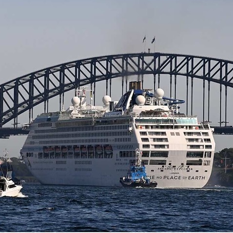 Tug boats with water cannons form a guard of honour and escort the P&O Cruises Australia flagship Pacific Explorer is it enters Sydney Harbour.
