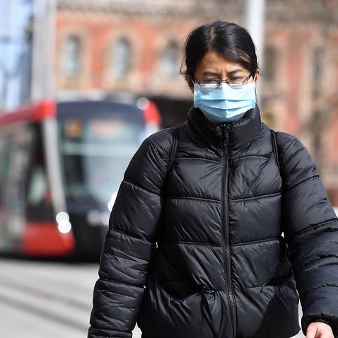 A pedestrian wearing a face mask in Sydney