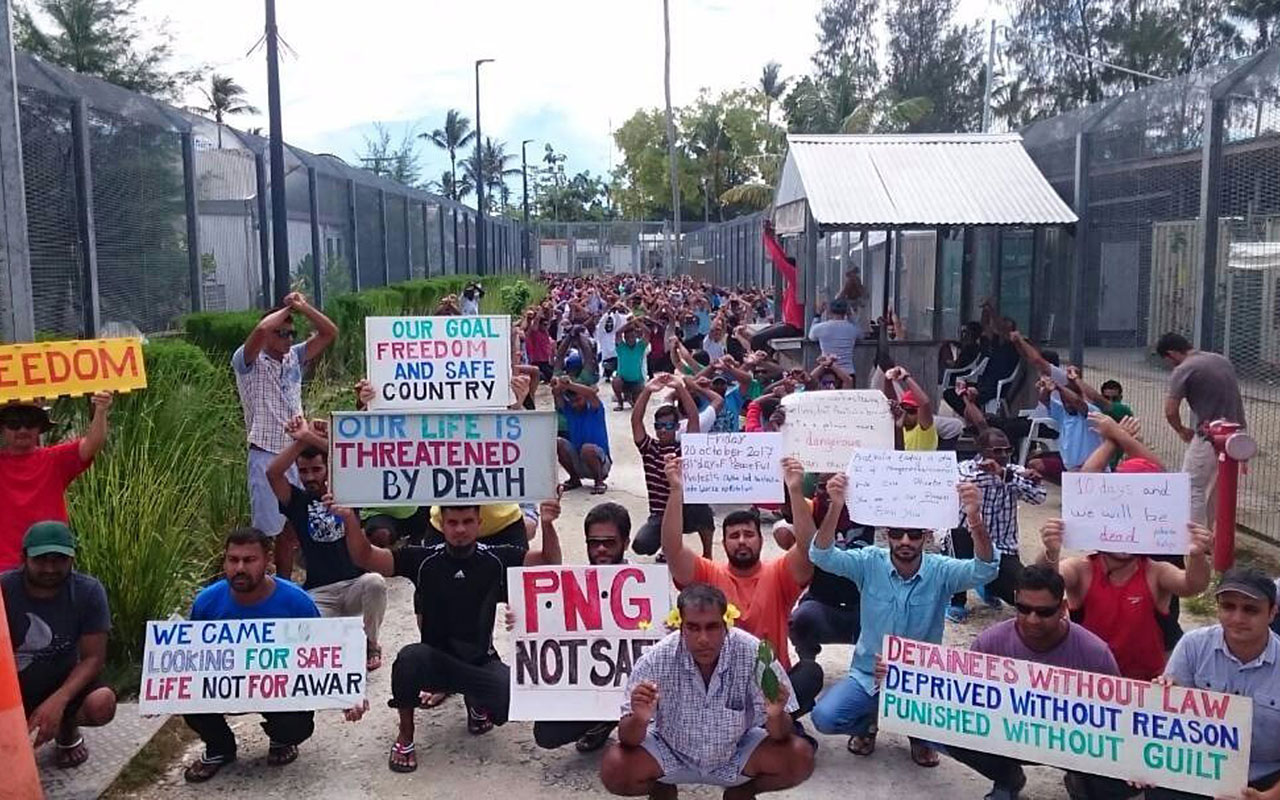 File image of  refugees and asylum seekers holding up banners during a protest at the Manus Island immigration detention centre in Papua New Guinea. 