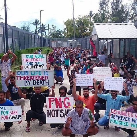 File image of  refugees and asylum seekers holding up banners during a protest at the Manus Island immigration detention centre in Papua New Guinea. 