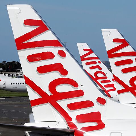 FILE - In this April 22, 2020, file photo, Virgin Australia planes are lined up at departure gates at Sydney Airport in Sydney, Australia