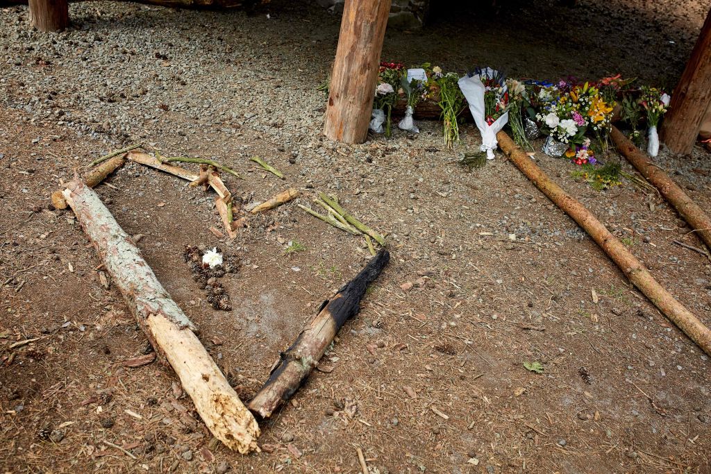 Flowers and pieces of wood shaping a heart left at the shelter where the body of Phillip Mbuji Johansen was found.