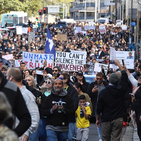 Protesters march along Broadway and George St towards Sydney Town Hall during the ‘World Wide Rally For Freedom’ anti-lockdown rally at Hyde Park in Sydney, Saturday, July 24, 2021. (AAP Image/Mick Tsikas) NO ARCHIVING