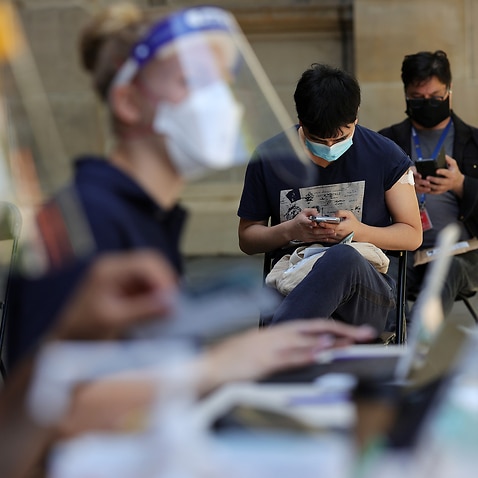 People are seen at a Cohealth pop-up vaccination clinic at the State Library Victoria, in Melbourne, Monday, 20 December, 2021. 