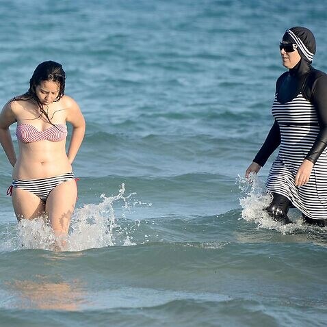 Tunisian women, one (R) wearing a 
