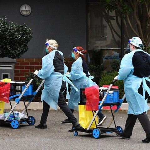 Healthcare workers are seen arriving to the Arcare Aged Care facility in Maidstone, Melbourne, Tuesday, June 1, 2021. Victoria has recorded three additional cases of coronavirus in the past 24 hours. (AAP Image/James Ross) NO ARCHIVING
