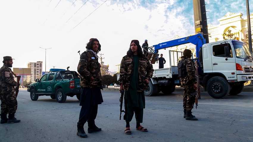Taliban members inspect the scene of a bomb blast in Kabul, Afghanistan, 4 December 2021.