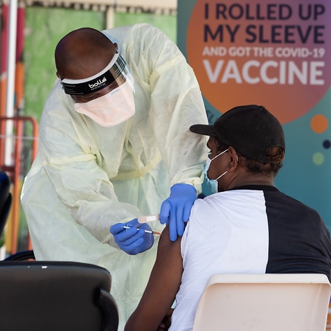 A health worker performs a vaccination at the Eastside walk in COVID-19 clinic, Katherine, Northern Territory.