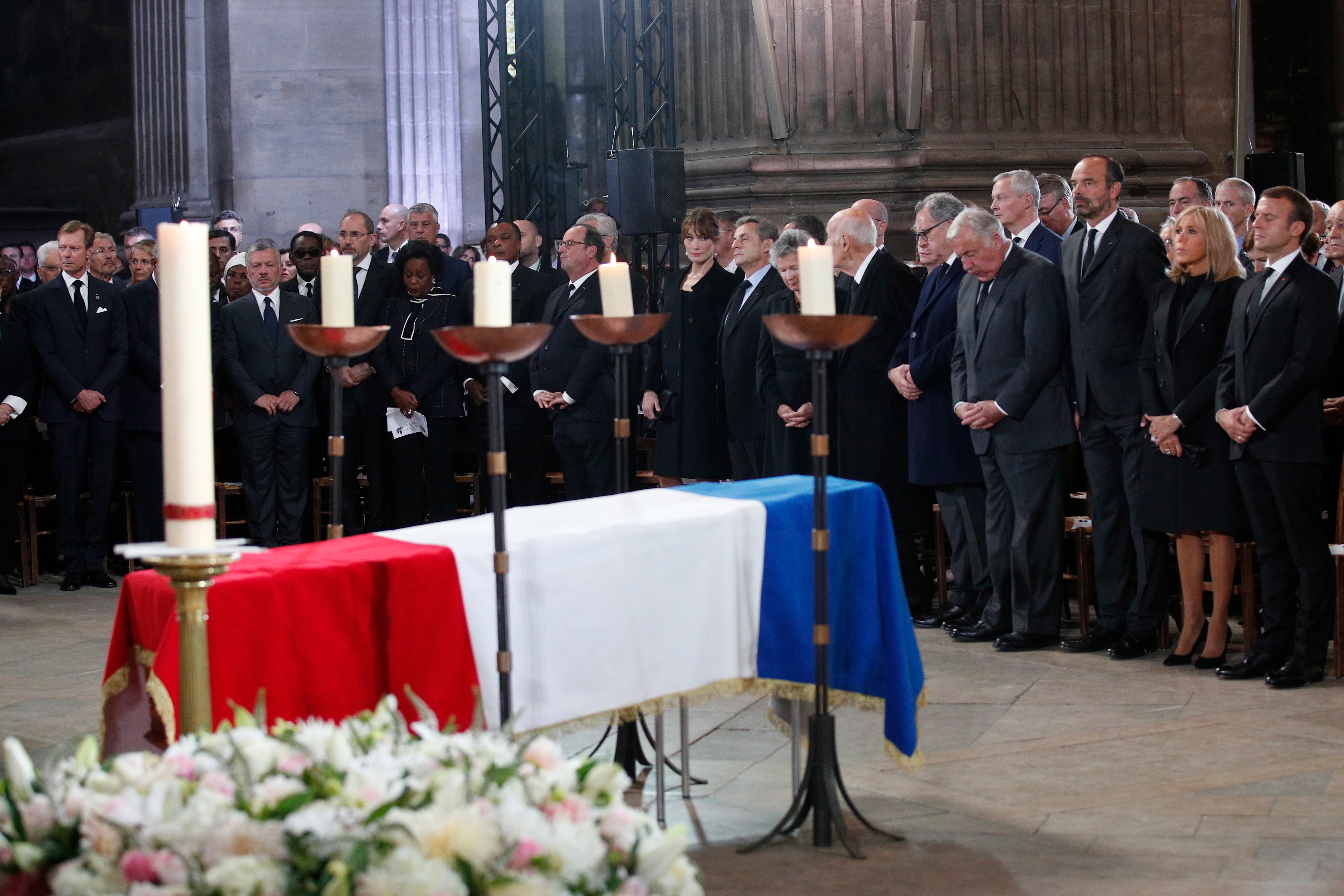 French President Emmanuel Macron (R) and his wife Brigitte (2-R), along with other French officials attend Jacques Chirac's funeral service.