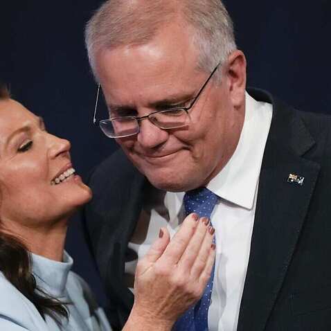 Australian Prime Minister Scott Morrison is embraced by his wife Jenny as he addresses a Liberal Party function in Sydney, Australia, Saturday, 21 May, 2022.