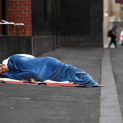 A homeless man sleeps in a laneway in Melbourne on March 23, 2020.