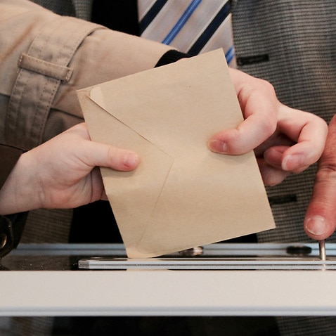 Image of a ballot box and the Thai ambassador to Australia