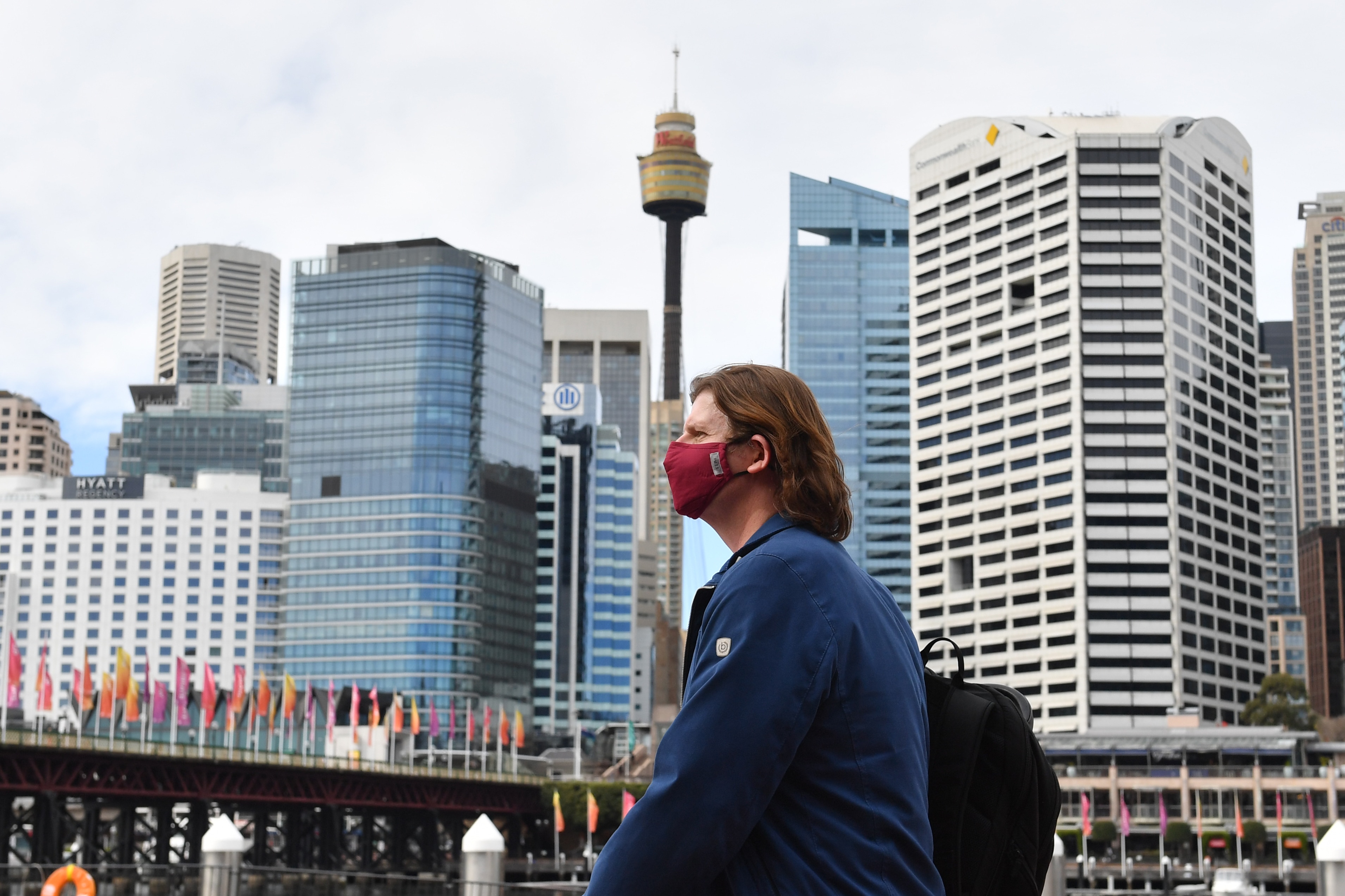 A pedestrian is seen wearing a face mask at Darling Harbour in Sydney on 4 August, 2020. 