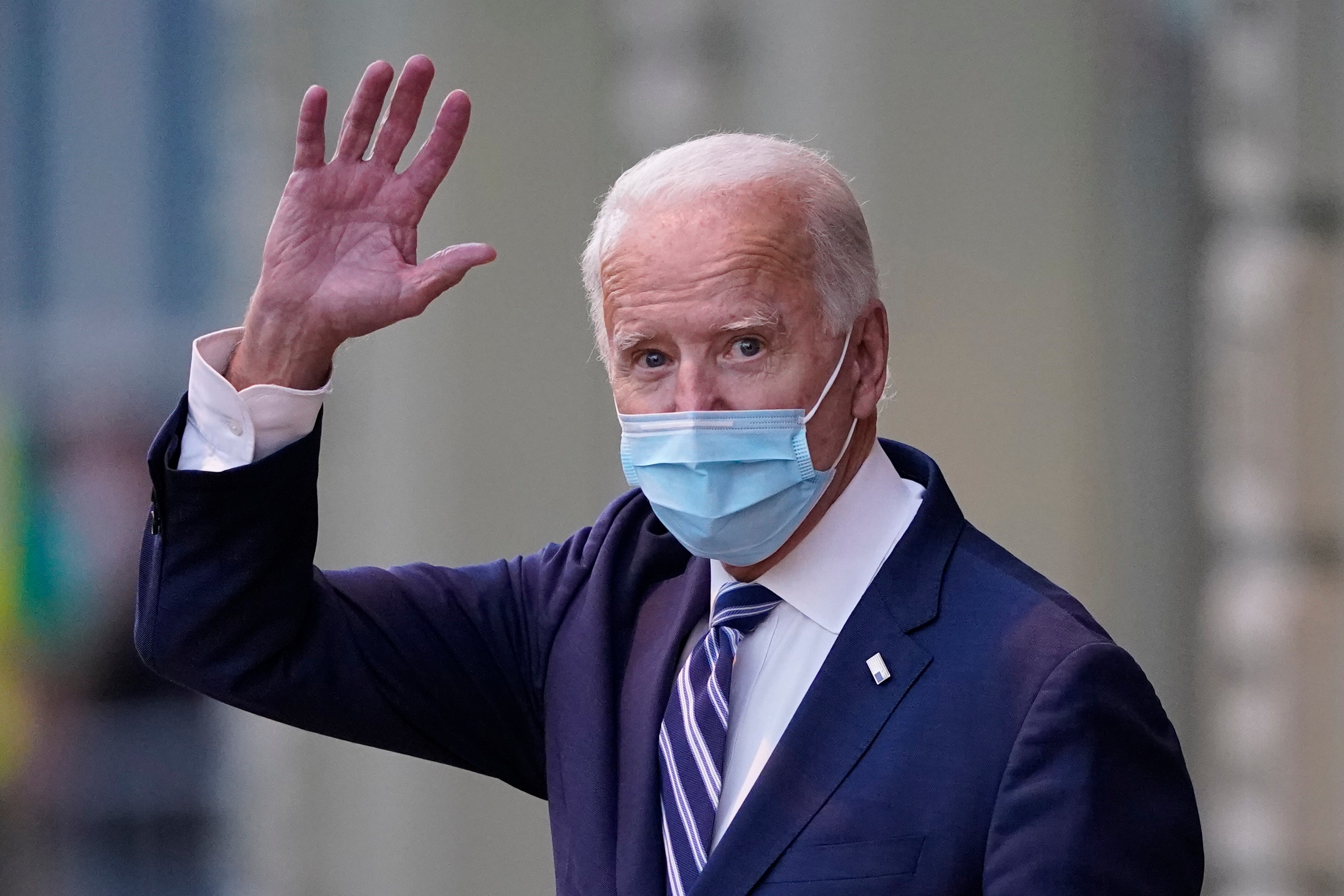 President-elect Joe Biden waves as he leaves The Queen theater.