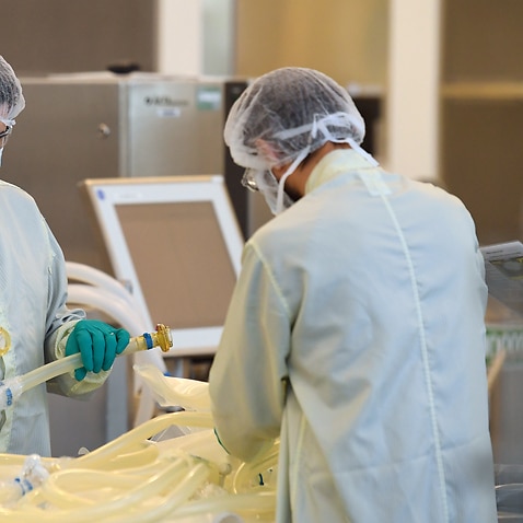 Scientists are seen at work inside of the CSL Biotech facility in Melbourne, Monday, September 7, 2020. 