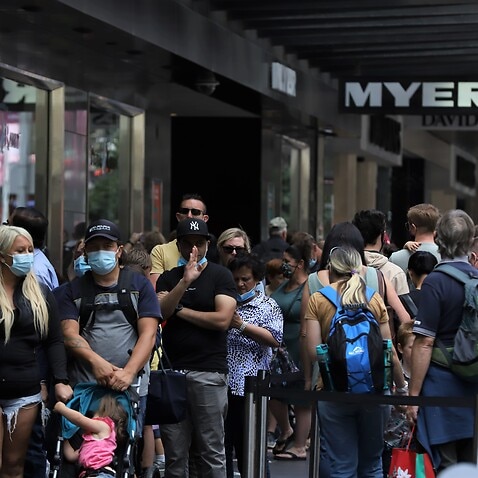 People wait to check Myer Christmas windows along Bourke Street Mall in Melbourne on 5 December 2021.