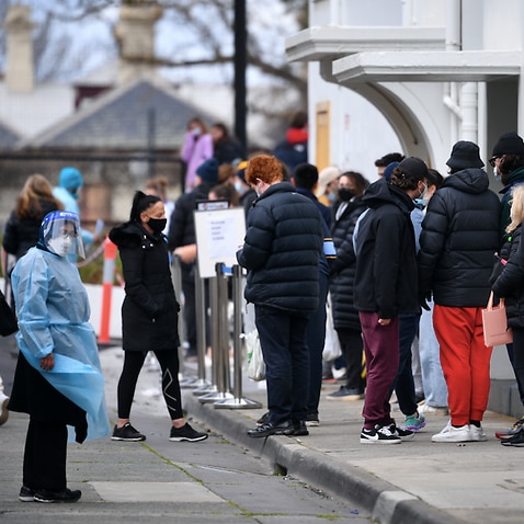 People are seen waiting in line at a COVID-19 vaccination centre in Melbourne, Thursday, August 26, 2021.