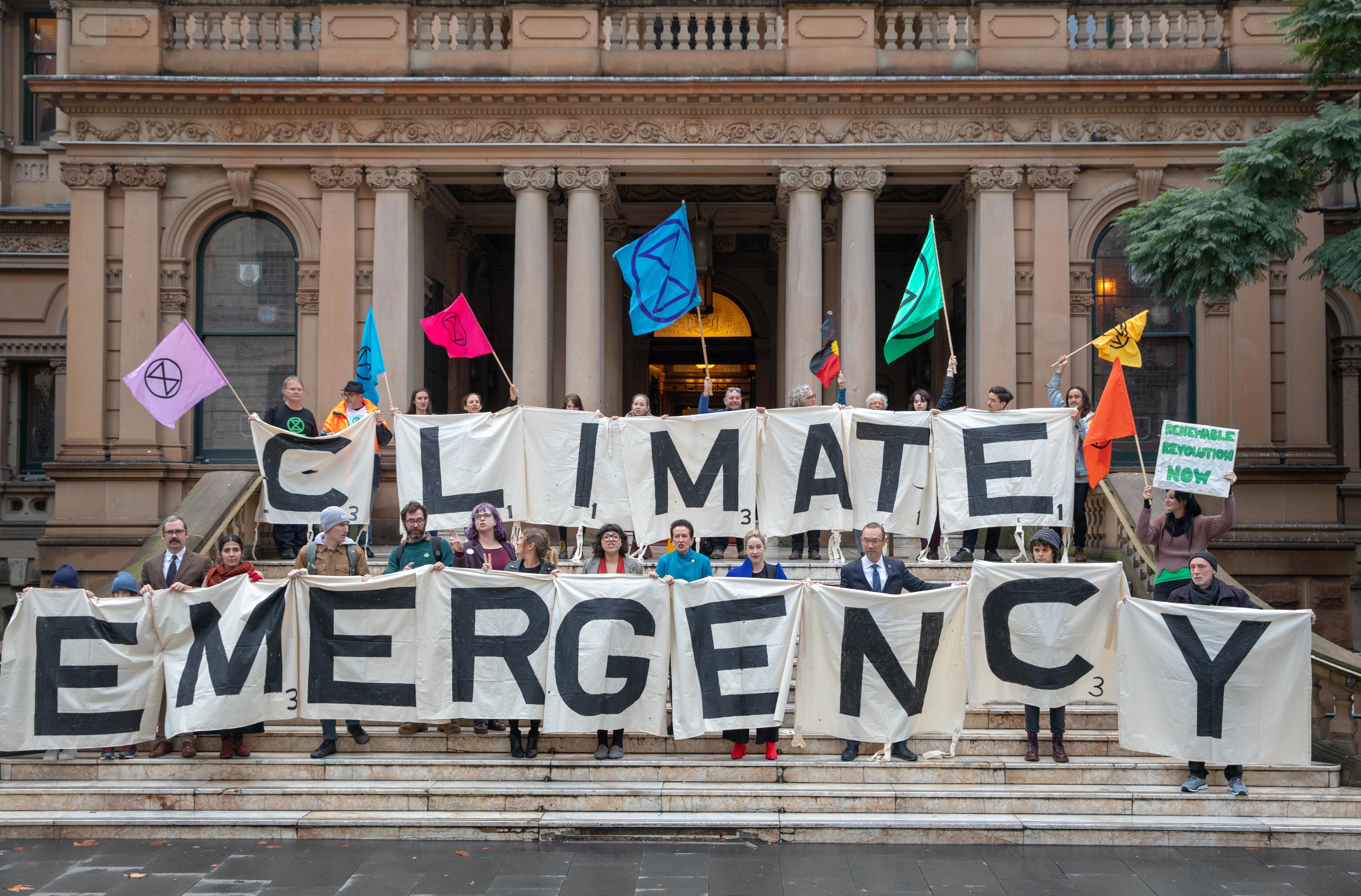 Activists from the Extinction Rebellion, Lord Mayor Clover Moore, Councillor Jess Miller, Councillor Jess Scully and Councillor Robert Kok at Sydney Town Hall.