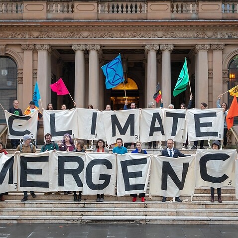 Activists from the Extinction Rebellion, Lord Mayor Clover Moore, Councillor Jess Miller, Councillor Jess Scully and Councillor Robert Kok at Sydney Town Hall.