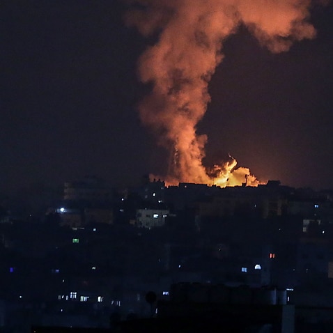 Smoke and flames rise after an Israeli airstrike in the northern Gaza strip, 14 May 2021. 