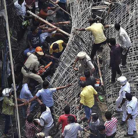 Locals and rescue workers look for survivors under the rubbles of a partially collapsed overpass in Kolkata, India, Thursday, March 31, 2016. 