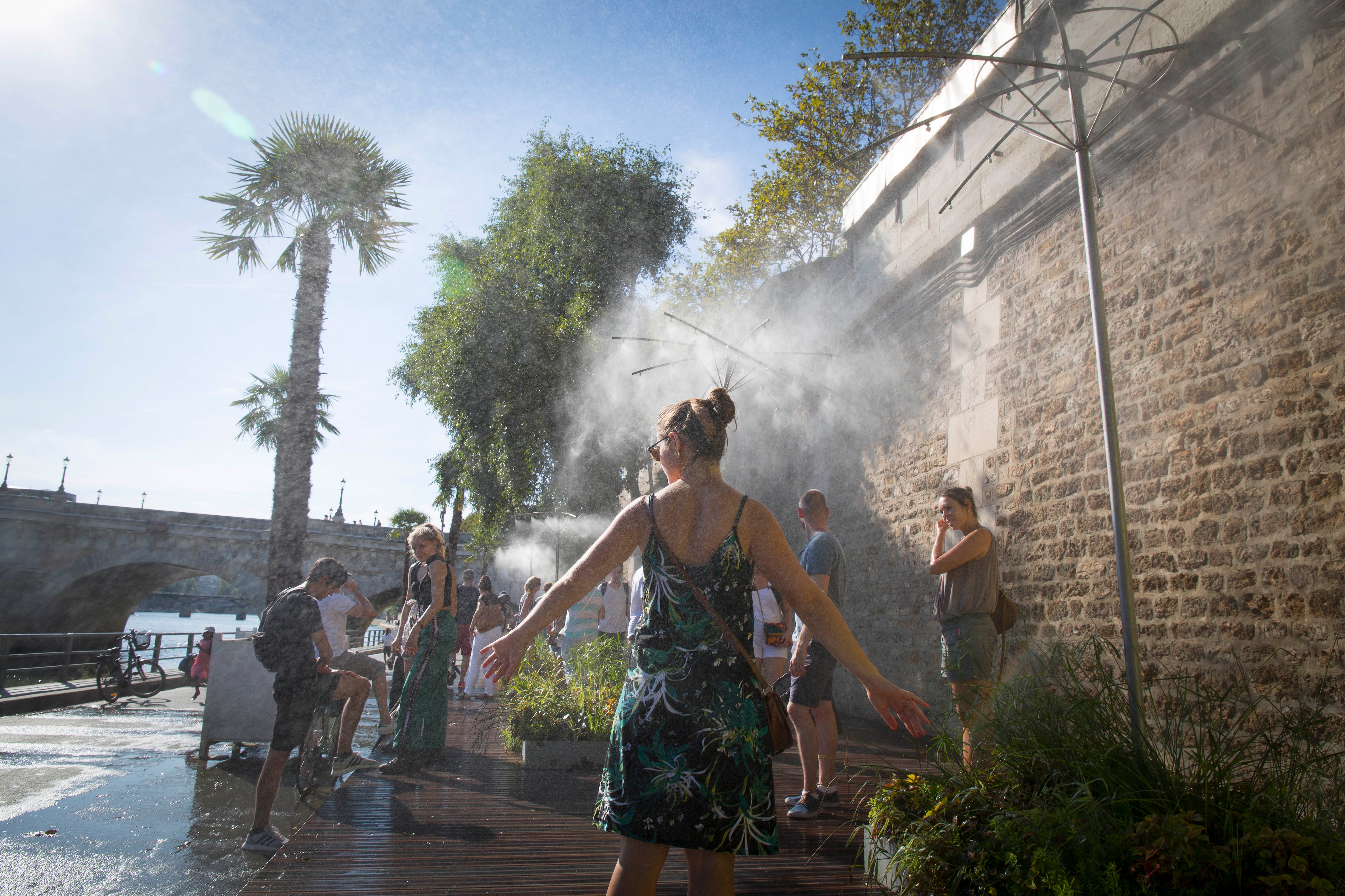 People cool off on the banks of river Seine in Paris.