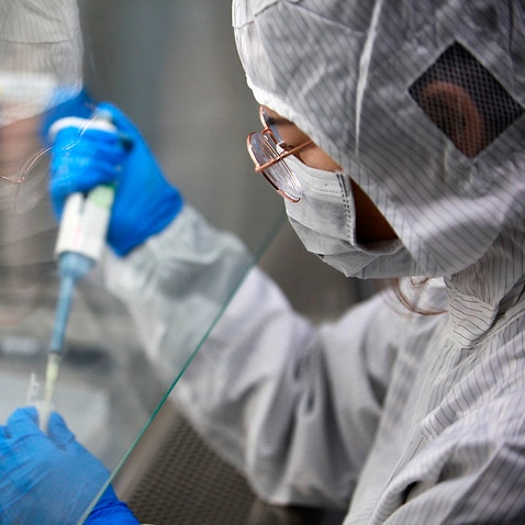 A technician examines the test kits for the coronavirus in China's Yangzhou city.