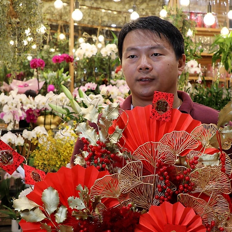 Chinese florist David Chen holding a special basket of flowers for Lunar New Year.