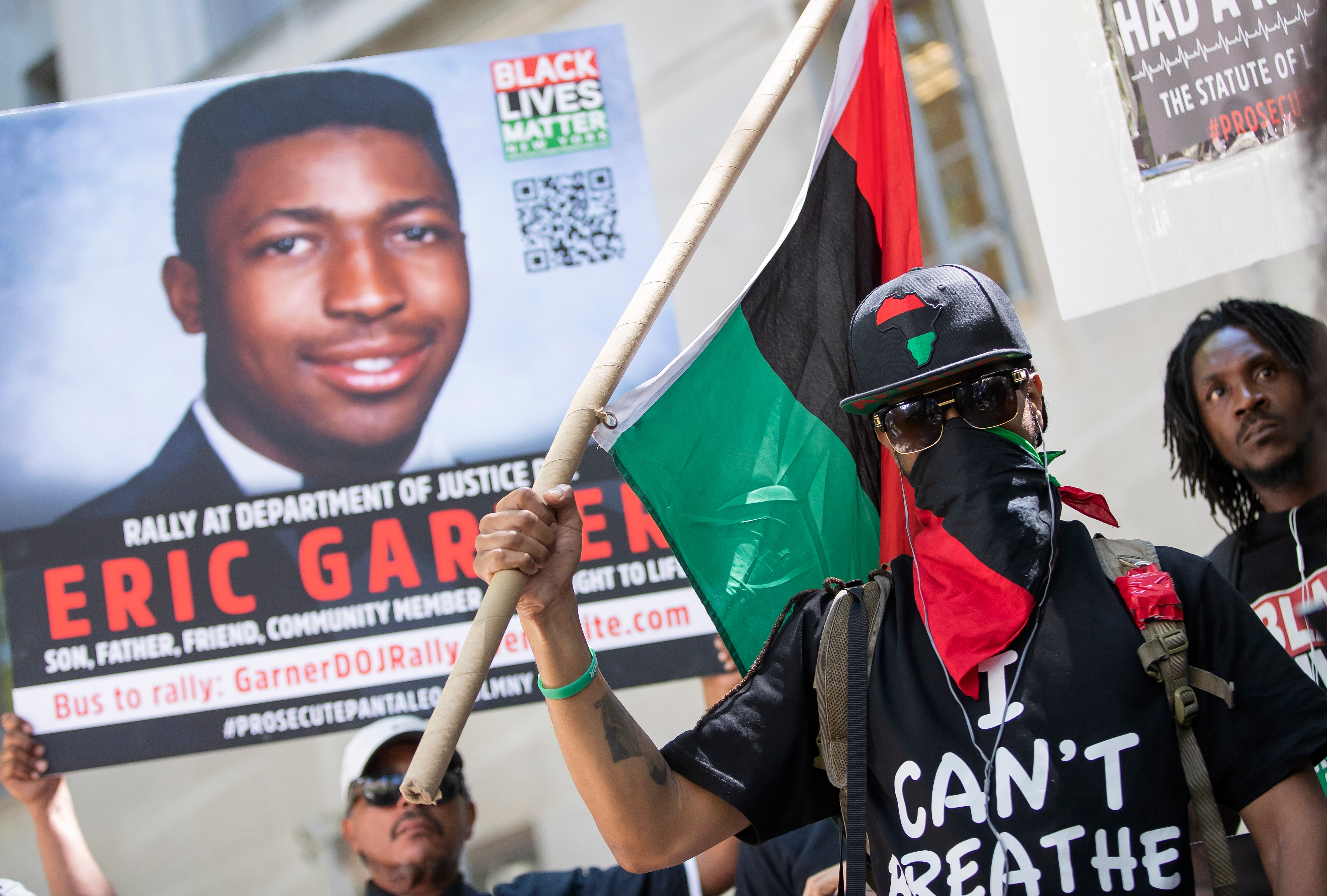 A man covers his face as he wears a shirt with Eric Garner's last words during a Black Lives Matter protest. A man covers his face as he wears a shirt with Eric Garner's last words during a Black Lives Matter protest.