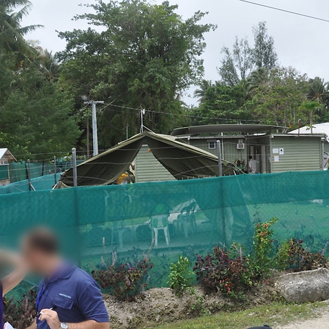 A green mesh fence surrounds Oscar compound at Manus Island