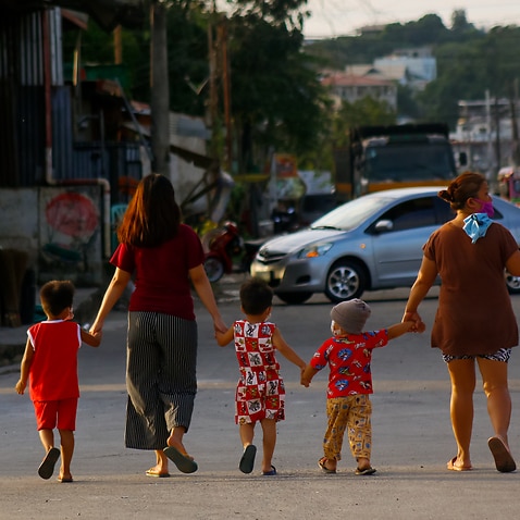 A file photo of women and children walking down a street in Rizal, Philippines on 16  January, 2021. 