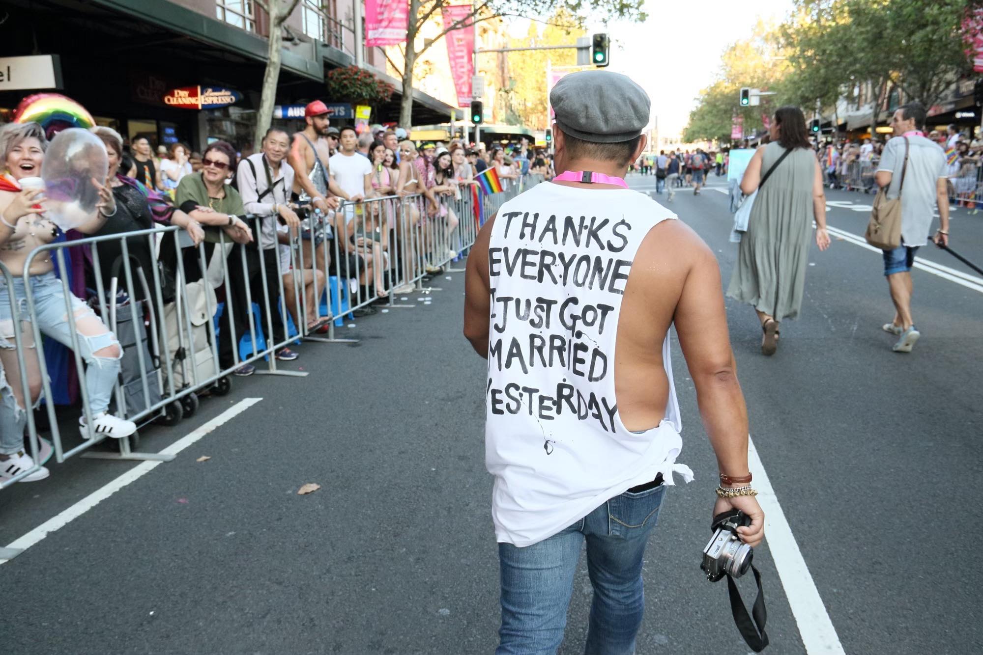 Sydney-based Japanese photographer Koichi Ogihara (Toboji) joined Mardi Gras Parade with his partner (pictured) in 2018, wearing a top with thank-you message.