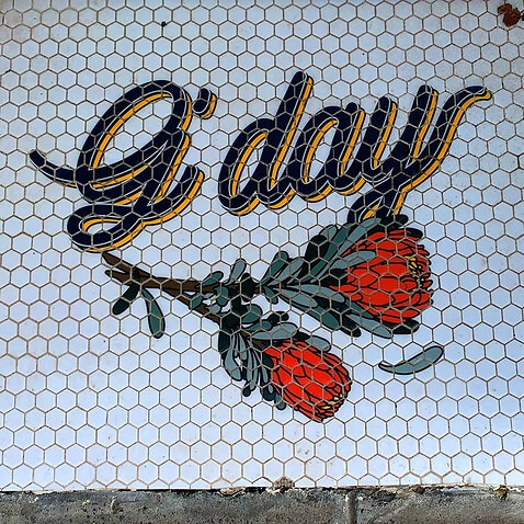 Image of paved tiles forming the word g'day, photograph by Emily Webster