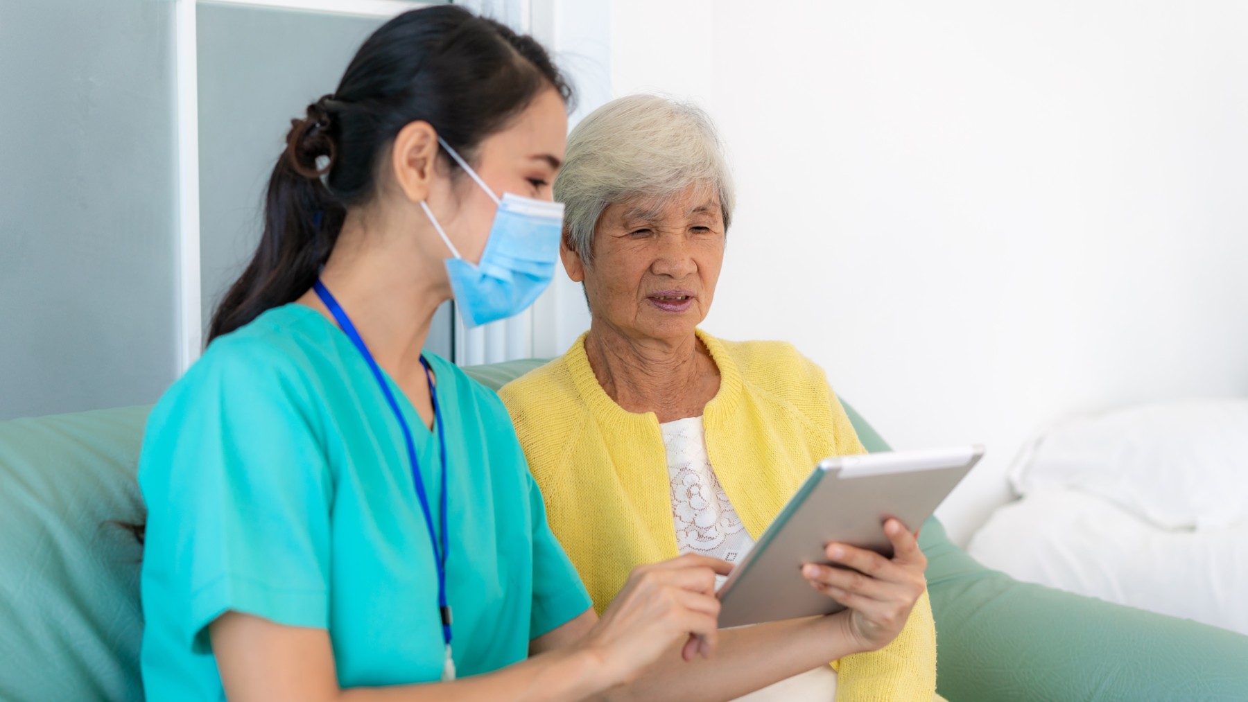 Nursing helping patient with tablet 