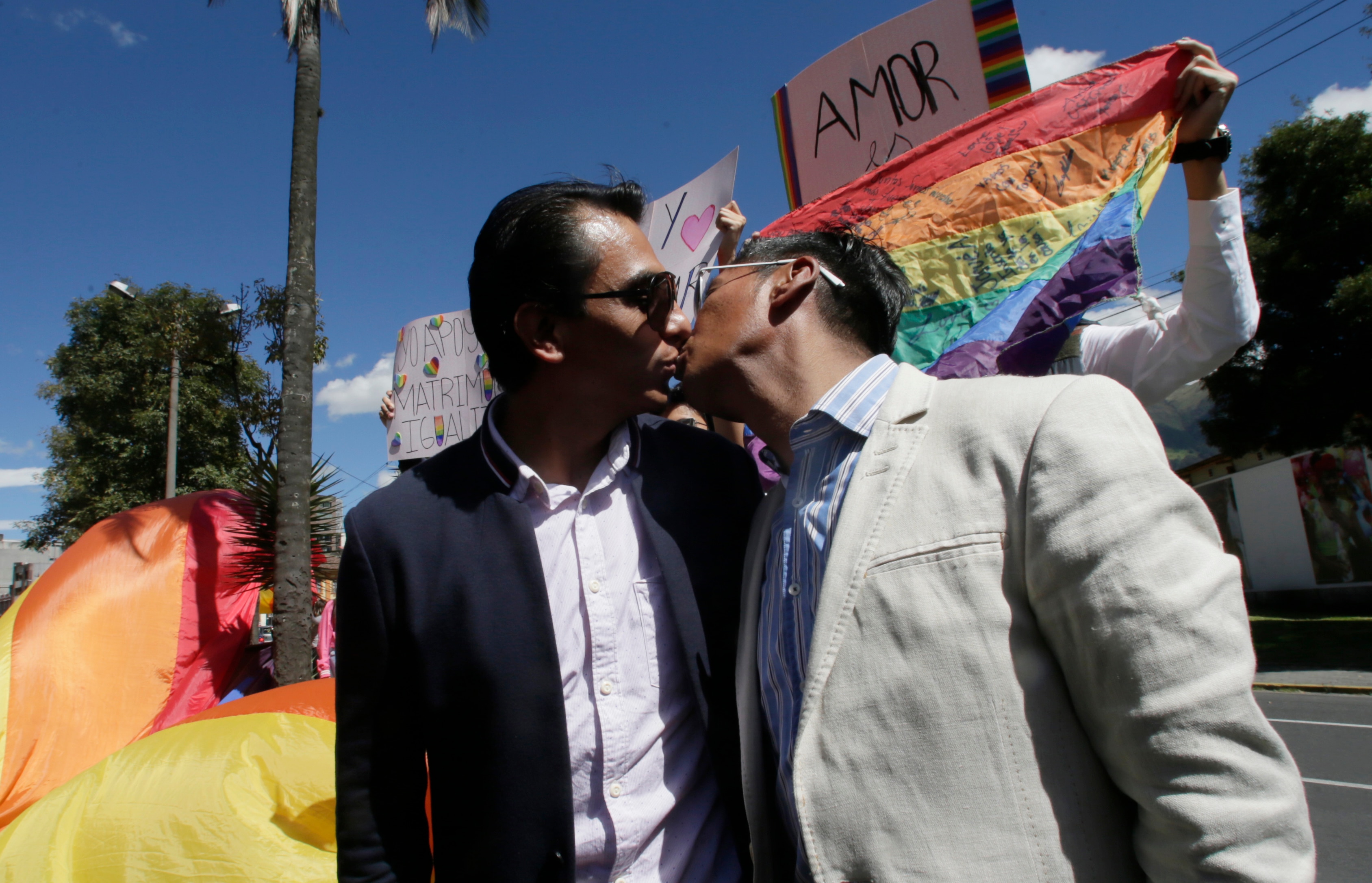 Javier Benalcazar, left, and his partner Efrain Soria kiss as they arrive to to know the final decision of the Constitutional Court.
