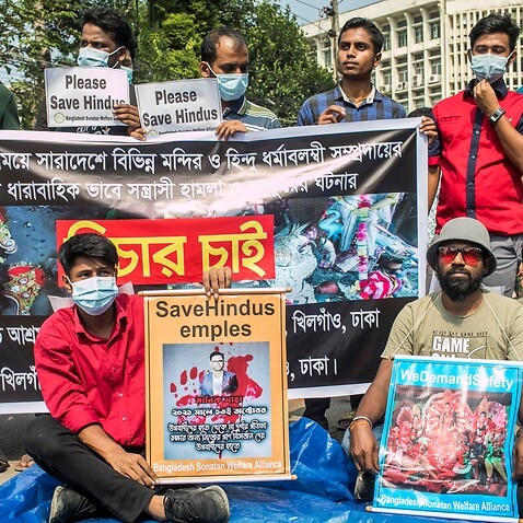 Protesters hold a banner and placards during the demonstration of Hindu Buddhist Christian Unity council in Bangladesh. 