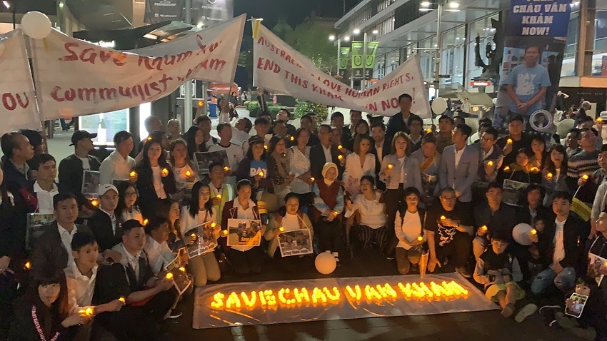 The family and supporters of Australian Van Kham Chau, a pro-democracy activist, gather for a candlelight vigil in Sydney.