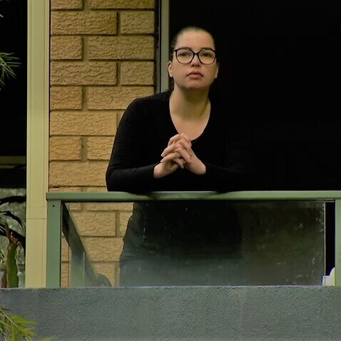 A pensive Renata Tavares Silva spending time on the balcony of her unit in Sydney.