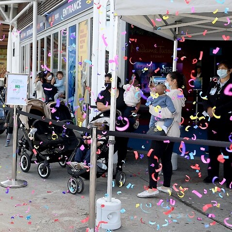 Staff fire confetti at the reopening of the Sea Life Aquarium at Darling Harbour in Sydney on 14 October 2021.