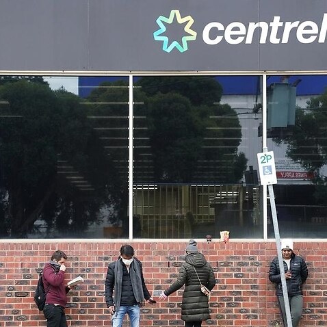 People are seen queuing outside a yet to open Centrelink office.