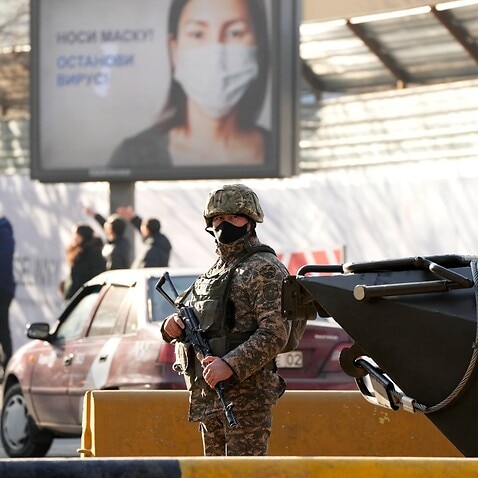 A Kazakhstan soldier guards a street in Almaty, Kazakhstan, Friday, Jan. 14, 2022. Life in Almaty has started returning to normal after days of unrest.