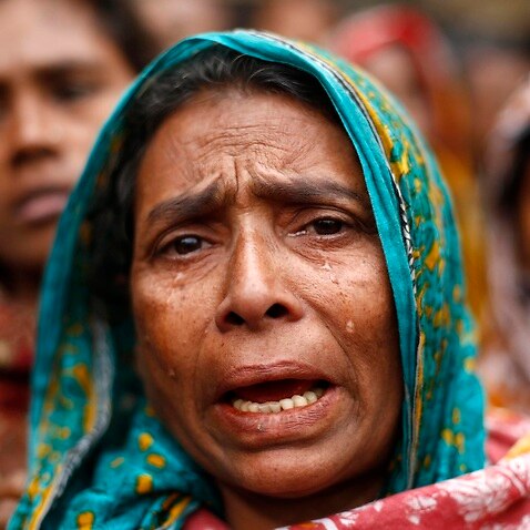 An evicted slum dweller cries and shouts slogans against authorities as they attend a protest rally during the celebration of the International Human Rights Day in Dhaka, Bangladesh