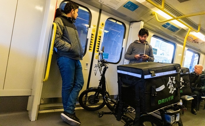 Food deliver bike riders on the train with their bicycles on May 13, 2020 in Melbourne, Australia.