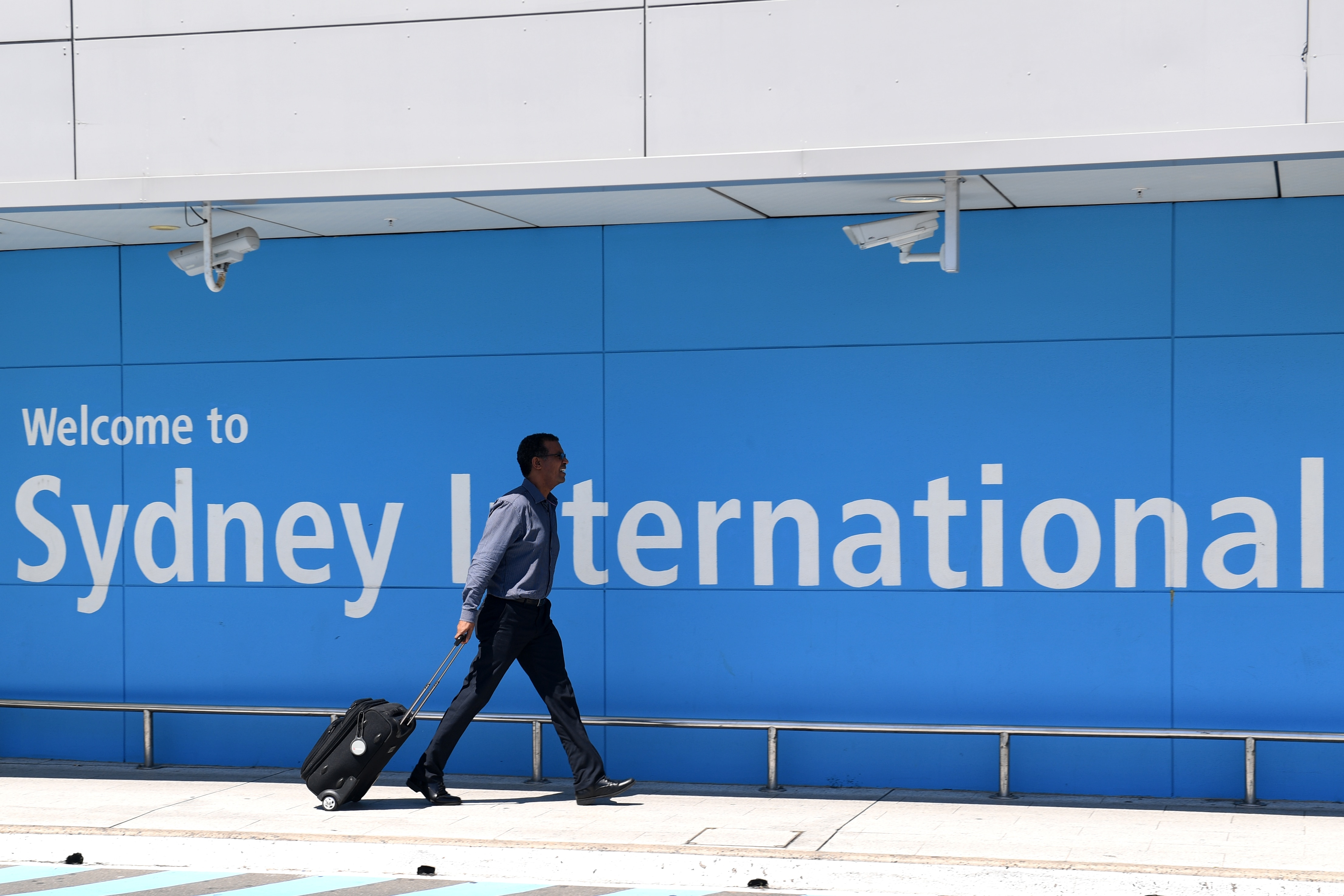 A passenger arrives at Sydney International Airport.