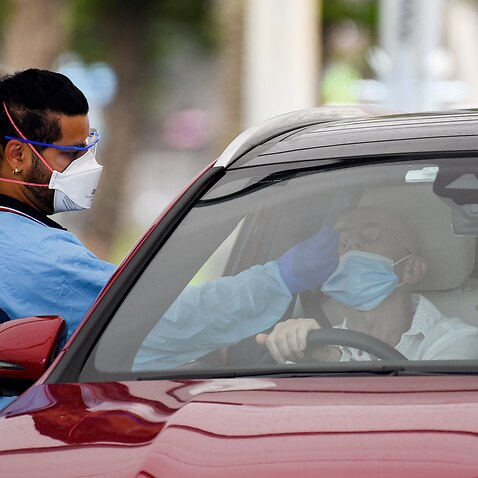 Healthcare workers administer COVID-19 tests at the St Vincent’s Hospital drive-through clinic in Sydney