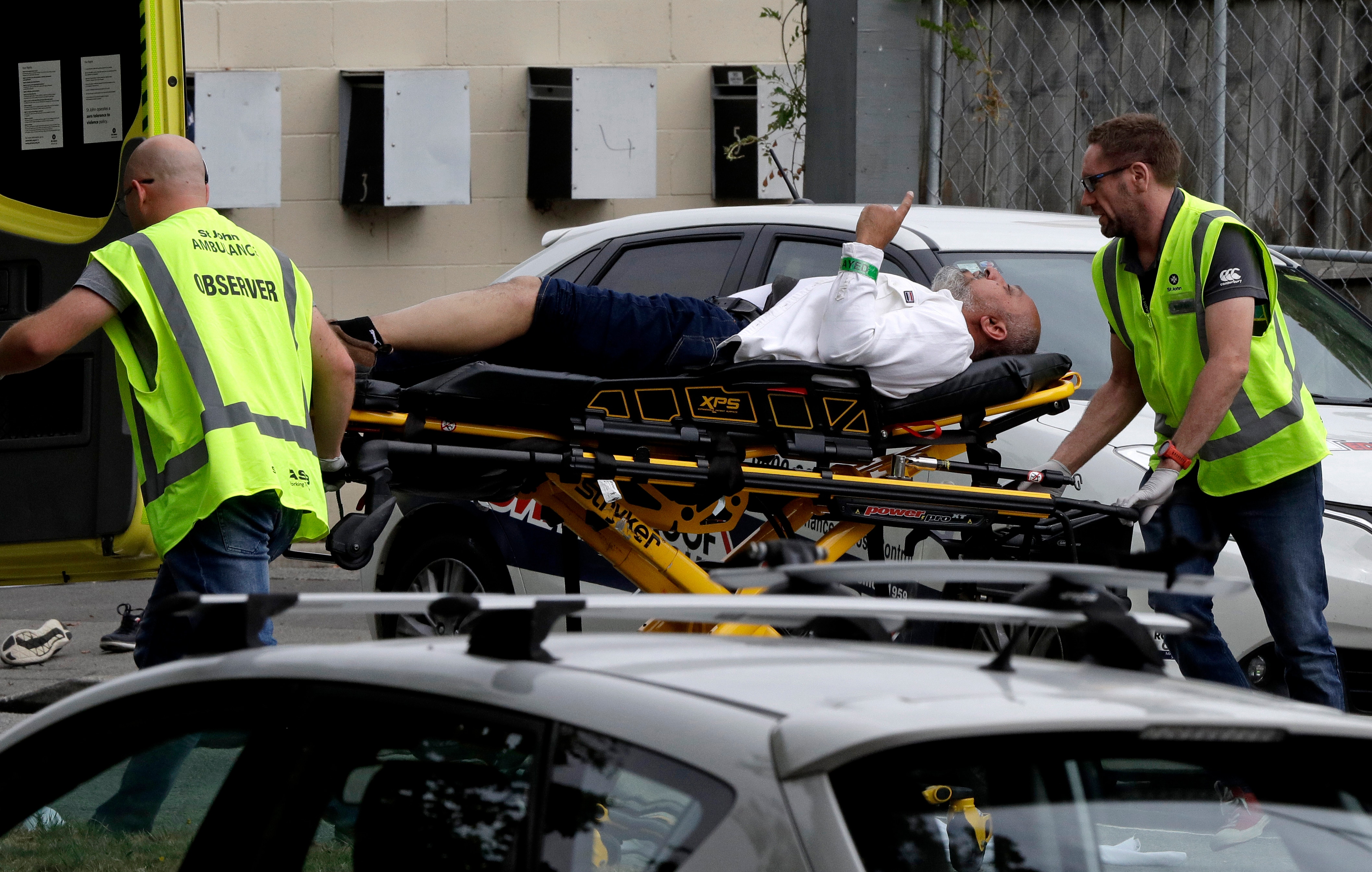 Ambulance staff take Mohsen Al-Harbi from outside a mosque in central Christchurch, New Zealand.