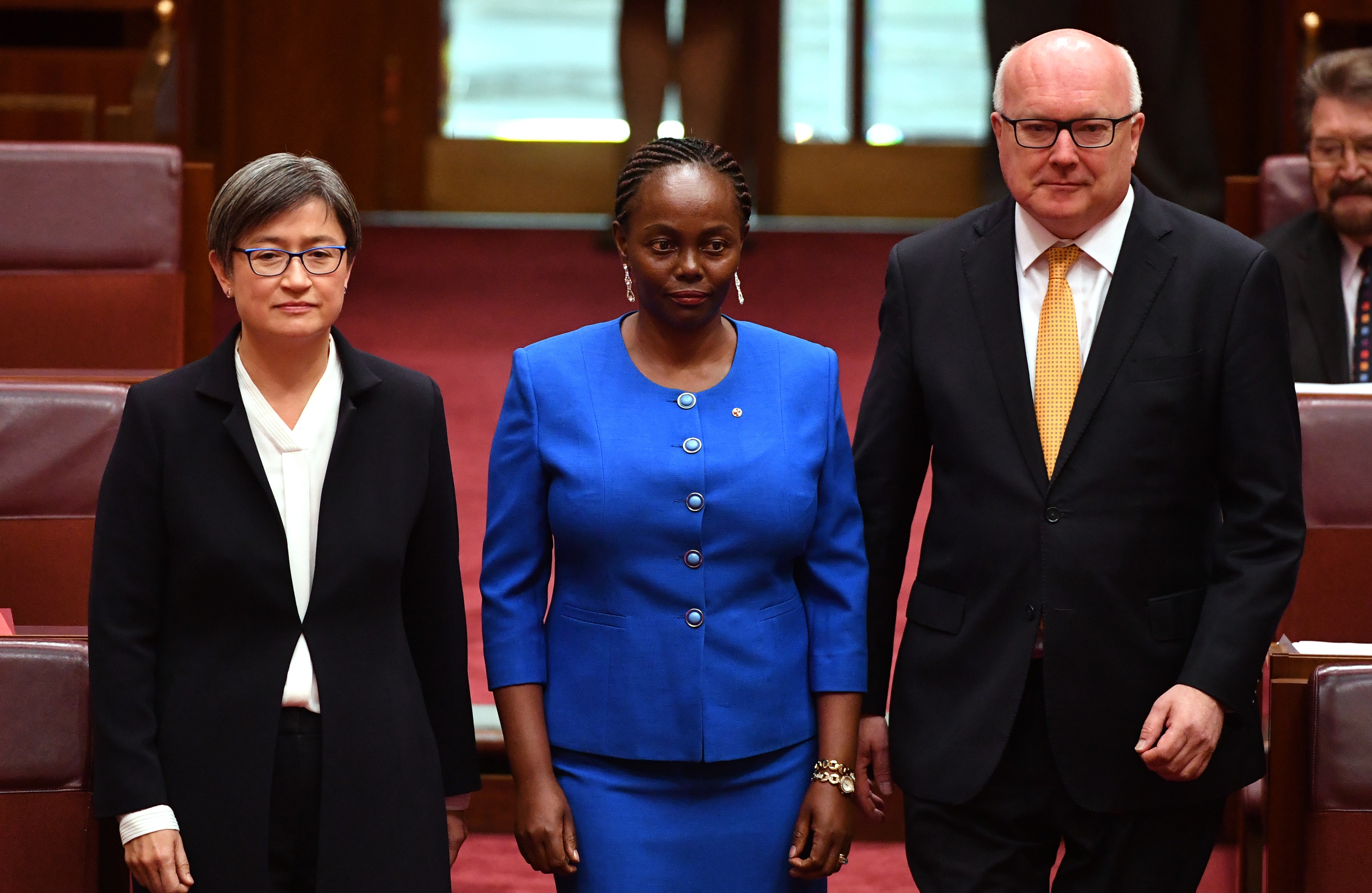 Lucy Gichuhi, centre, arrives for her swearing-in ceremony at Parliament House in Canberra on 9 May 2017.