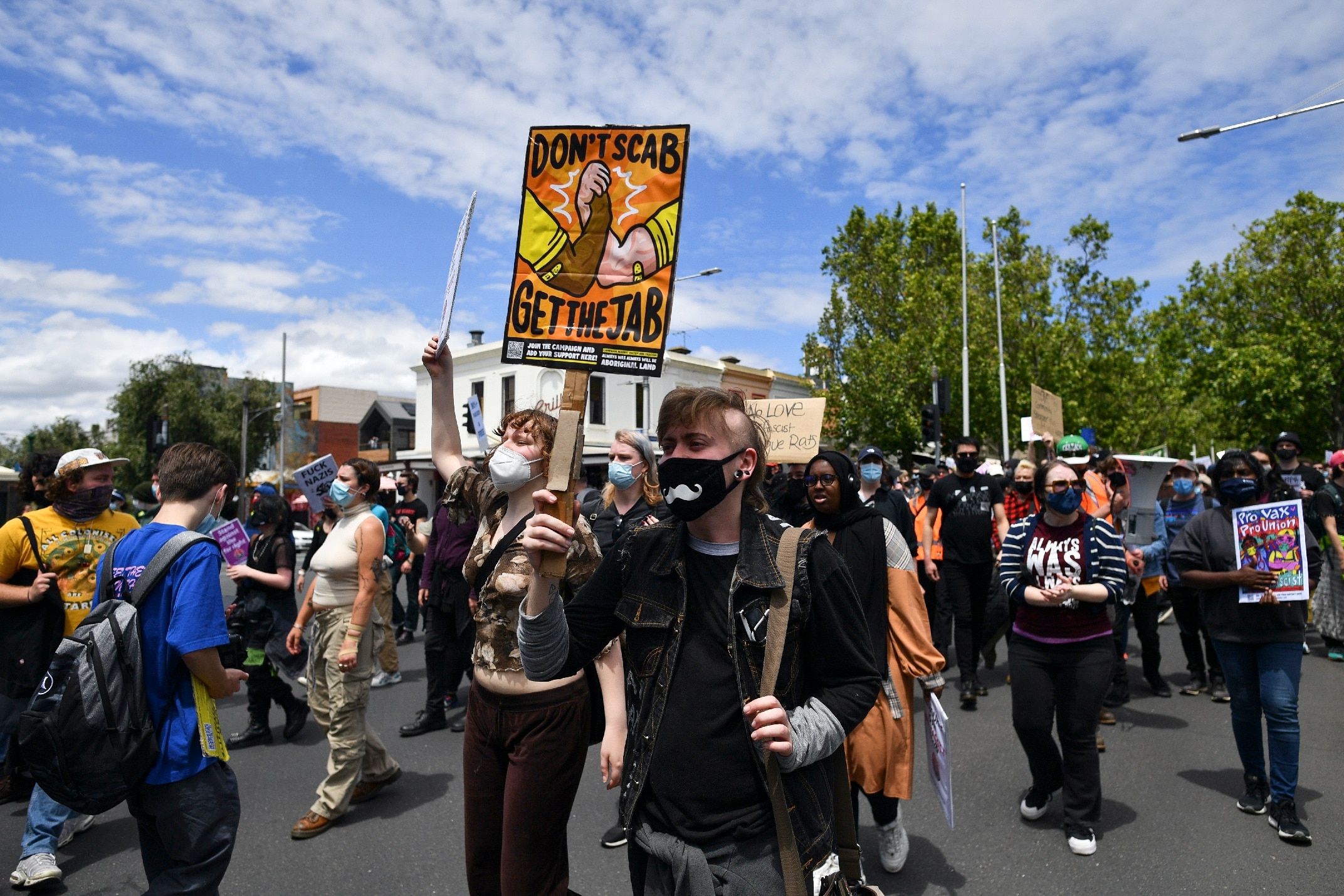 Those in support of vaccination held protests in Melbourne to counter anti-vaccination protesters with the former wearing masks. 