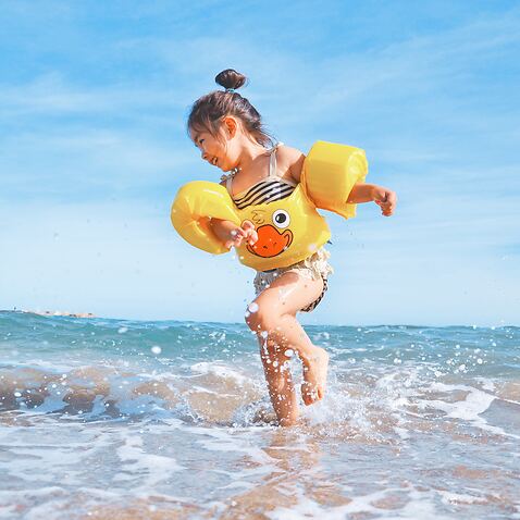 Happy child playing on the beach